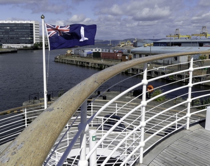 The NLB flag flying high in the wind on a spring day in Leith.