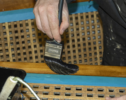 A close-up look at varnishing the rope box.
