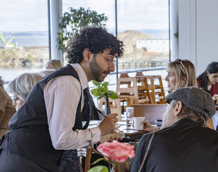 Waiter service in the Royal Deck Tea Room as Waiter, Rameen, takes an order