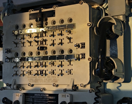 Sunlight hits the multiway internal telephone system for command and control at the Bridge.