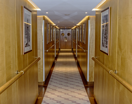 A corridor on board Fingal showing handrailings and cabin doorways, which are labelled with the cabin names.