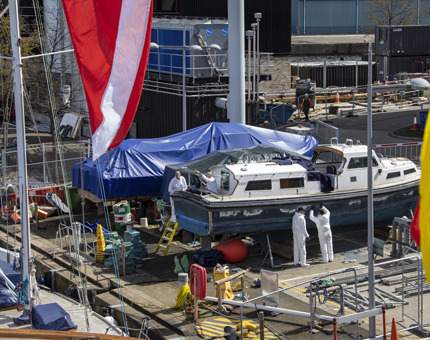 Four Yotties working on the Fast Motor Launch. 