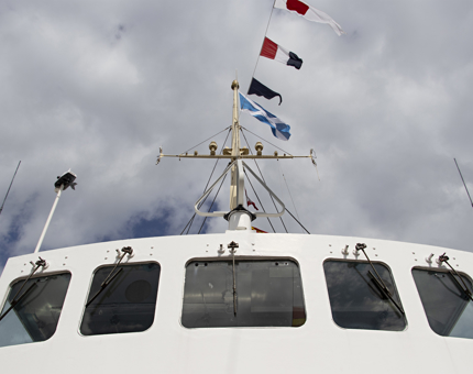 Looking up at the outside of the Bridge at Britannia with the dress flags above.