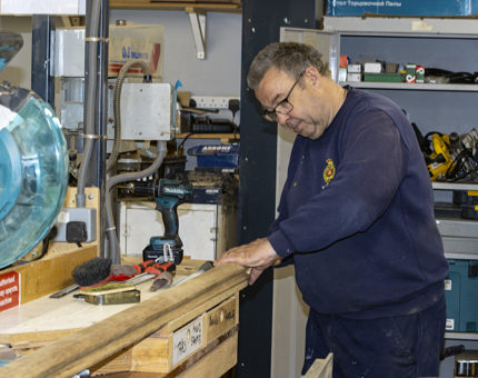 A man in the Maintenance workshop finishing the handrails for Fingal.