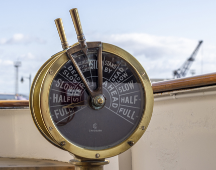 The engine order telegraph on board Fingal. This is a round dial with two handles and indicator pointers. 