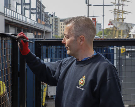 A man painting an outside lift.