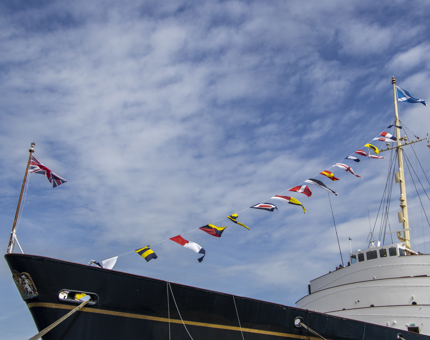 The bow of Britannia with dress flags.