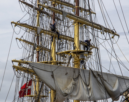 A tall ship docked at Leith with three tall masts.