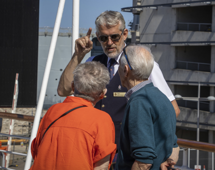 A Visitor Assistant speaking to two visitors.