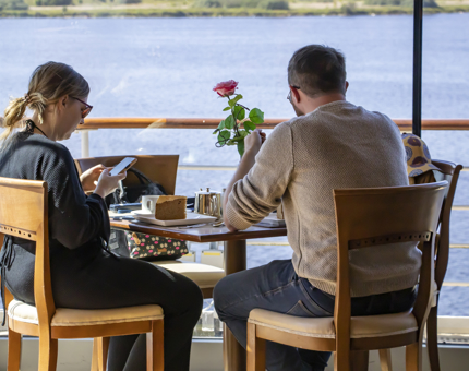 A couple sitting at a table in the Tearoom enjoying a slice of cake.