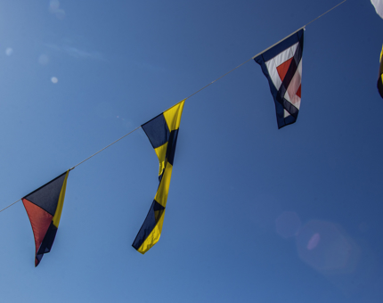 Multi-coloured dress flags fluttering in the wind.