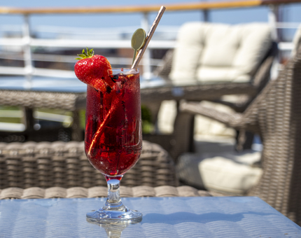 A bright red cocktail on an outside table at Fingal. 