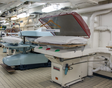 A large press inside the onboard Laundry.