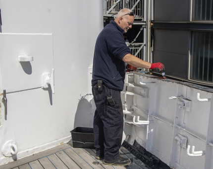 A man applying primer paint. 