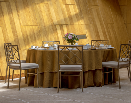 A round table set for Afternoon Tea in the sun-dappled Ballroom at Fingal. 