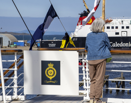 A visitor looks out at the view on the Verandah Deck. 