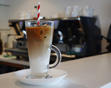 An iced coffee in a tall glass. 