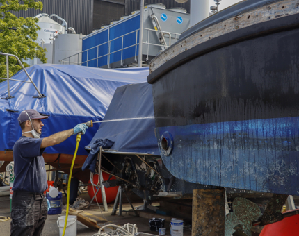 A member of the Maintenance Team hosing down the FML.