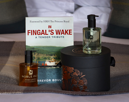 The book 'Fingal's Wake' with a hatbox containing luxury bathing products. 