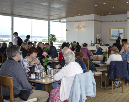 Groups of visitors sitting in the Tearoom.