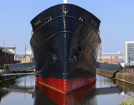 The bow of Fingal in Leith with a clear blue sky. 