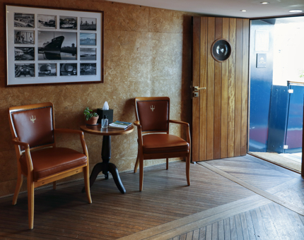 The Reception at Fingal, containing two chairs and a small table with a black and white photo montage on the wall. 