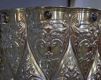 A close-up detail of a silver punch bowl. 