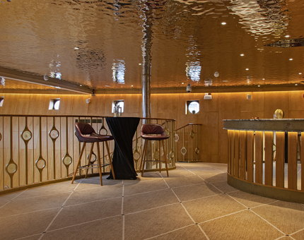 The Ballroom Bar upstairs at Fingal with a shimmering ceiling, table and two tall chairs. 
