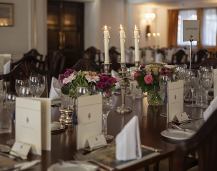 The tables in the State Dining Room aboard The Royal Yacht Britannia are set for an evening event. 