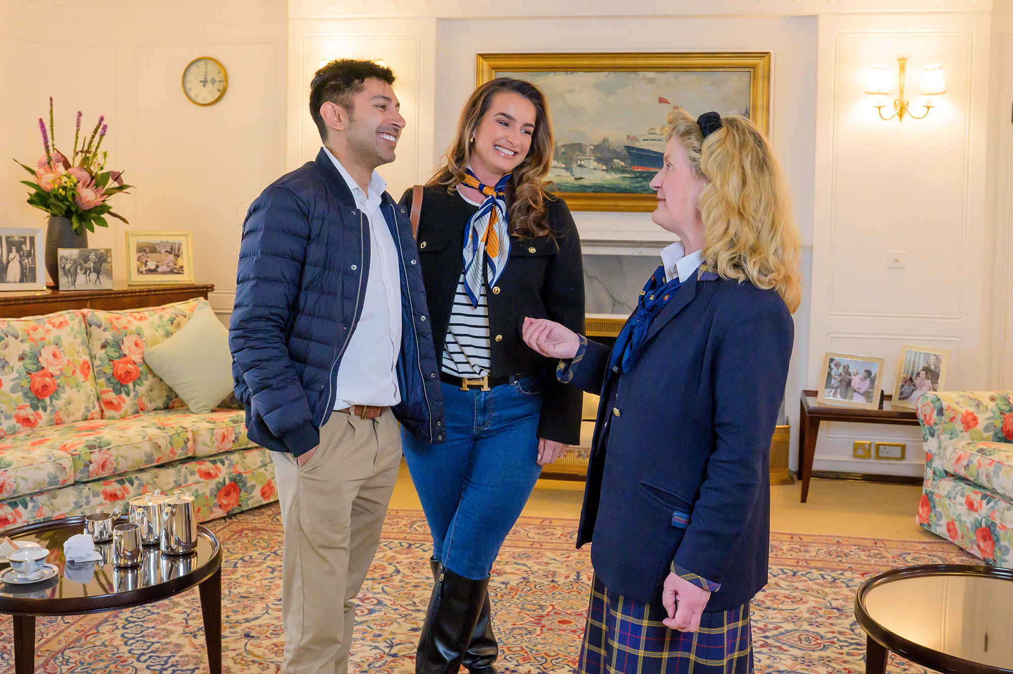 Two visitors to Britannia in Edinburgh talking to a Visitor guide.