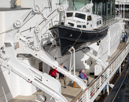 A view of a life boat hanging on the side of Britannia in Leith. 