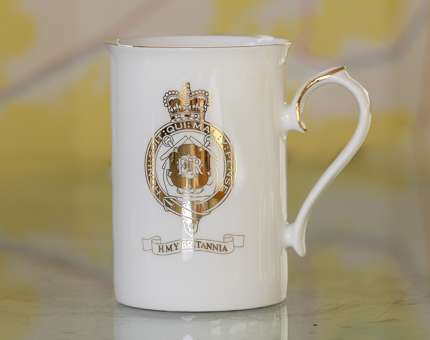 A gold-crested Royal Yacht Britannia coffee mug. 
