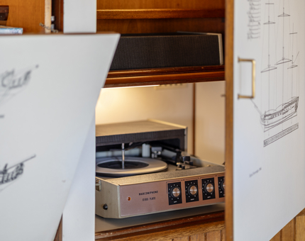 An open cabinet with a record player inside it. 