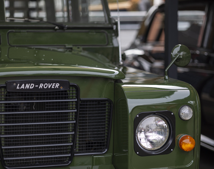 A close up of the Land Rover on the Quayside. It is painted green. 