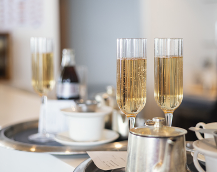 In the Royal Deck Tearoom, trays of drinks are on the bar, ready to be served. 