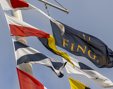 A close up of dress flags and a Fingal flag flying in the wind.