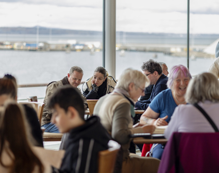 People sitting at tables in The Royal Deck Tearoom. 