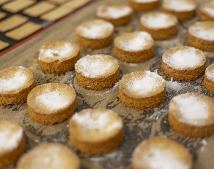 A tray of round biscuits prepared for an Afternoon Tea sweet treat. 