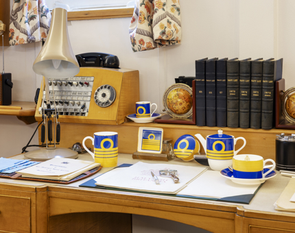 A collection of china from the Admiral's collection. It has been displayed on a desk. 