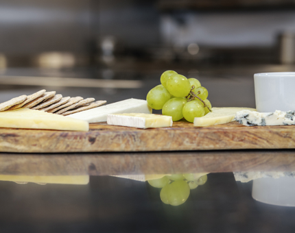 A cheeseboard on the bench in the Galley,