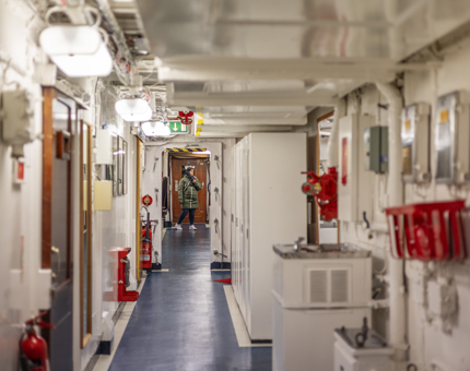 A long hallway with a visitor at the end. 
