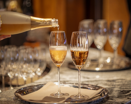 Glasses of fizz being poured.