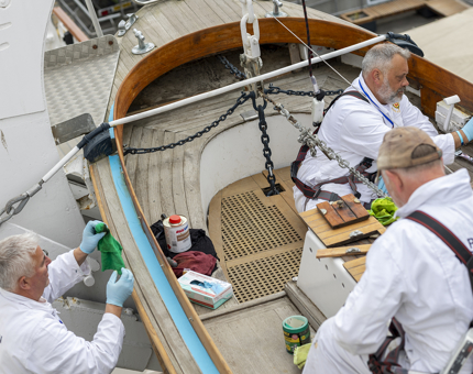 Three Yotties working on a Whaler boat.