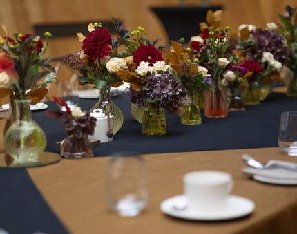 A close up of autumnal flowers in the middle of the table in Fingal's Ballroom.